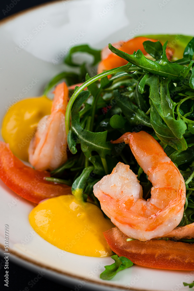 Salad from shrimp tails with lettuce, arugula, cherry tomatoes, avocado, olive oil and balsamic vinegar.