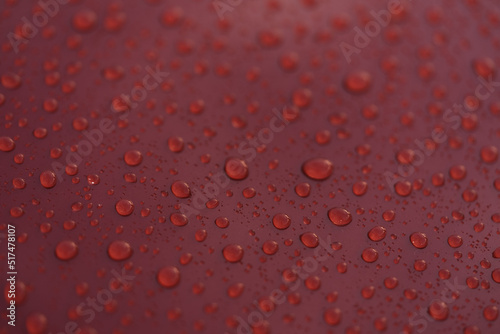 Raindrops on car paint surface after protection treatment