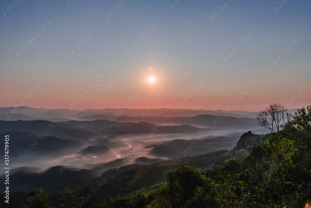 
The view from the mountain with the morning sunrise, beautiful, with a thin mist on the ground with the color of the sky being twilight.