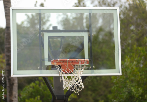 view of board with basketball hoop and net. Evening sky at sunset background. photo