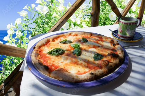 Italian pizza Margarita served on sea view terrace