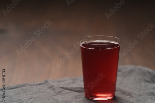 berry drink in thin glass on wood table with copy space