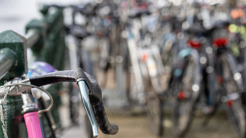 Many bicycles standing on a canal in Amsterdam - selective focus Many bicycles standing on a canal in Amsterdam - selective focus