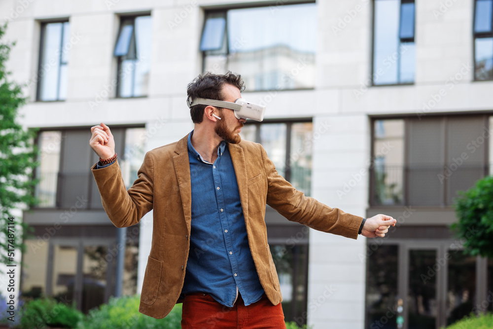 Portrait of man in virtual reality glasses. Guy in VR headset watching 3d movie, playing in VR games, enjoys virtual tour of tourist attractions. Businessman works in cyberspace.