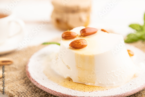 Ricotta cheese with honey and almonds on white wooden. side view, selective focus.