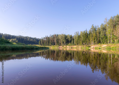 beautiful day on the river, shore and tree reflections in the water, Gauja river, Latvia