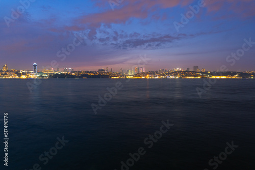 Panorama of Istanbul at night, long exposure with silky water and basques in movement, the tall buildings of the city are observed. © Montse