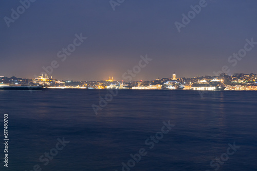 Panorama of Istanbul at night, long exposure with silk water and basques in movement, the mosques and the Galata tower are observed.