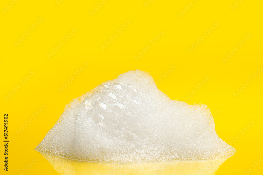 Drop of fluffy bath foam on yellow background - obrazy, fototapety, plakaty 