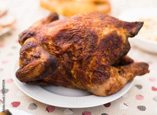 ruddy chicken fried whole on a plate on the festive table