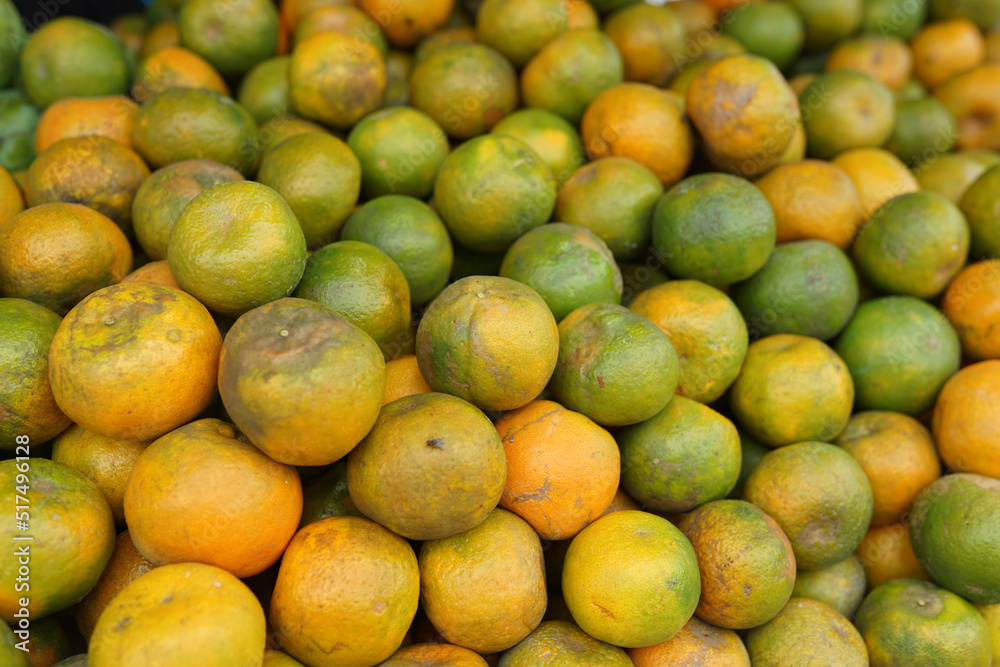 oranges and neat arrangement of fruit in baskets at the traditional market. healthy and fresh orange fruit background