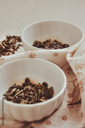 Small bowls with dried healing green tea and herbs, ritual purification and cleansing, closeup