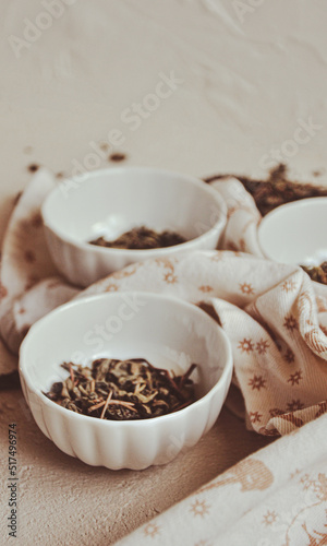 Small bowls with dried healing green tea and herbs, ritual purification and cleansing, closeup