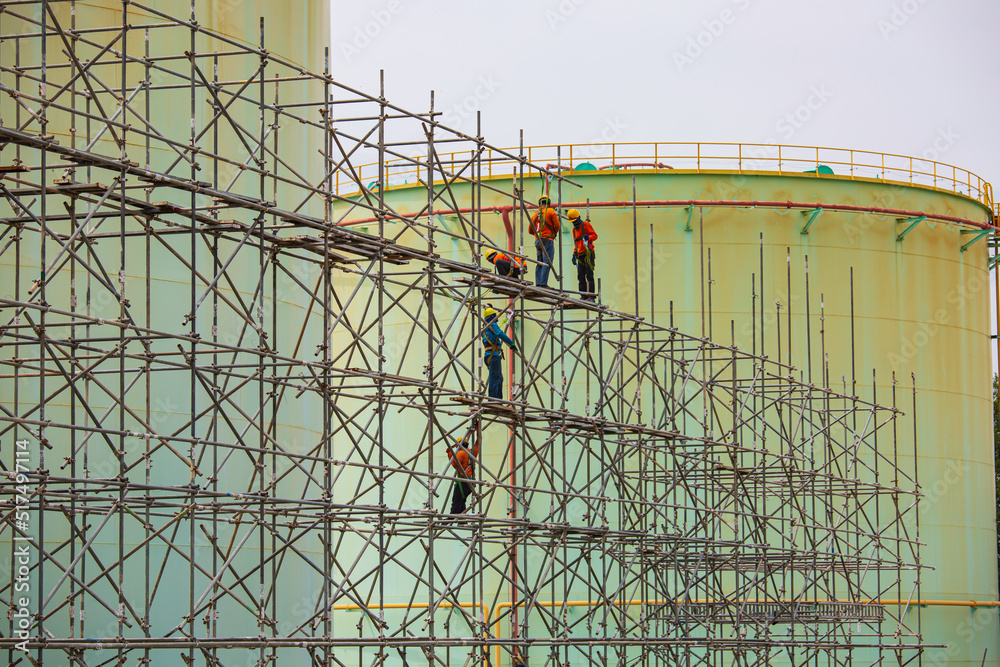 Worker male assembly in progress storage new tank  oil inspection scaffolding