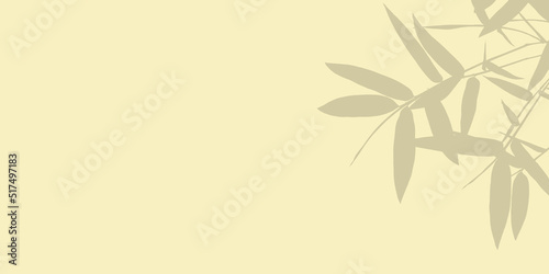 Shadow of bamboo leaves is placed on light backdrop and copy space.
