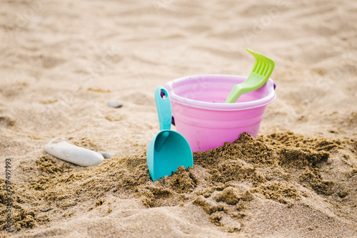 Children's beach toys on sandy beach.