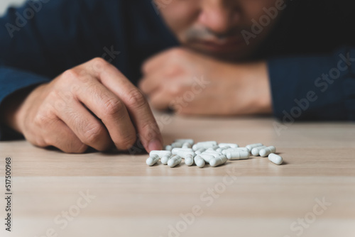 the person using drug overdoses lying on the table. close up on pills