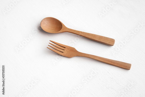 Kitchenware, a wooden spoon and fork on white top view