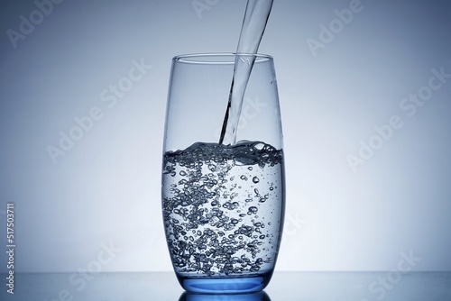 photo pouring water into a glass