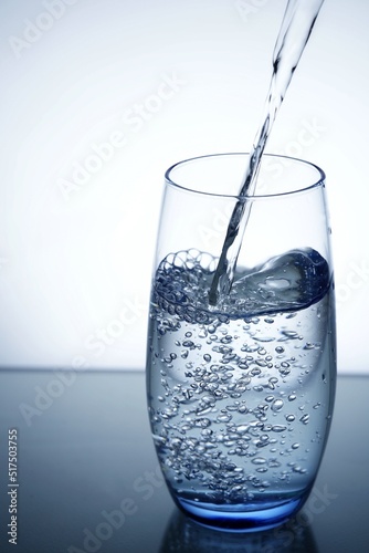 photo pouring water into a glass