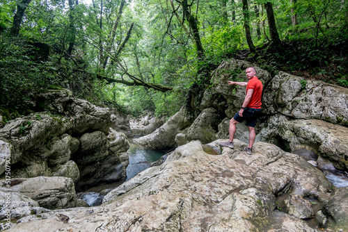 A male traveler admires the canyon of the Agura River in Sochi.