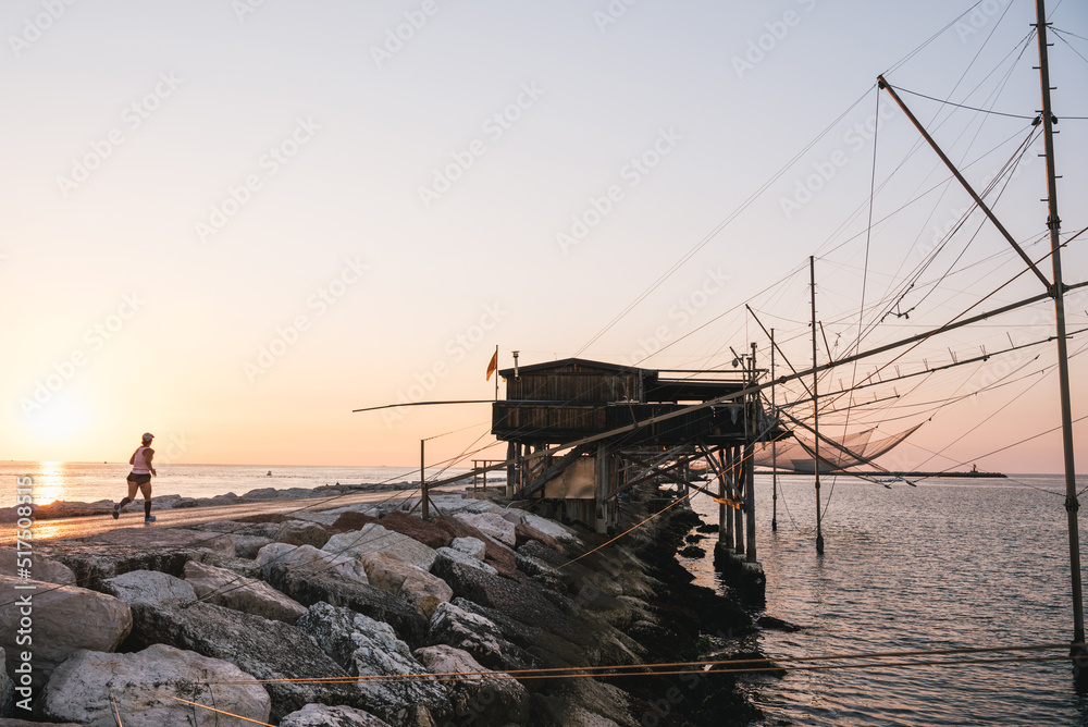 Traditional fishing house at sunrise, Dam of Sottomarina, Chioggia, Italy.
