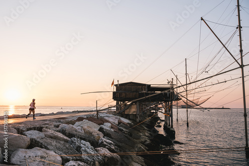 Traditional fishing house at sunrise, Dam of Sottomarina, Chioggia, Italy.