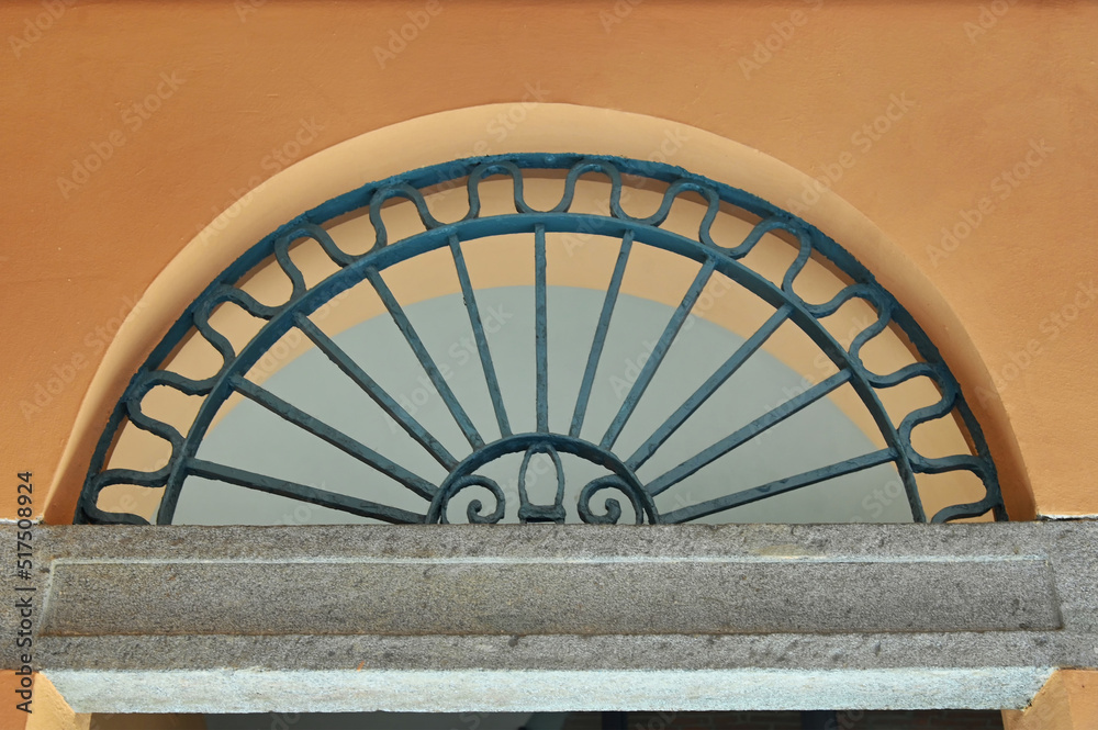 Fototapeta premium close detail of an ancient portal made of stone and wrought iron