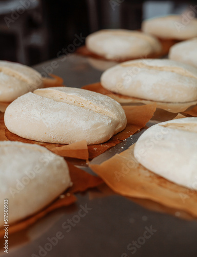 shaped bread raw dough before baking on the table in bakery