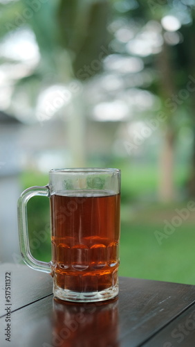 A glass of hot tea on a wooden table, copy space, background