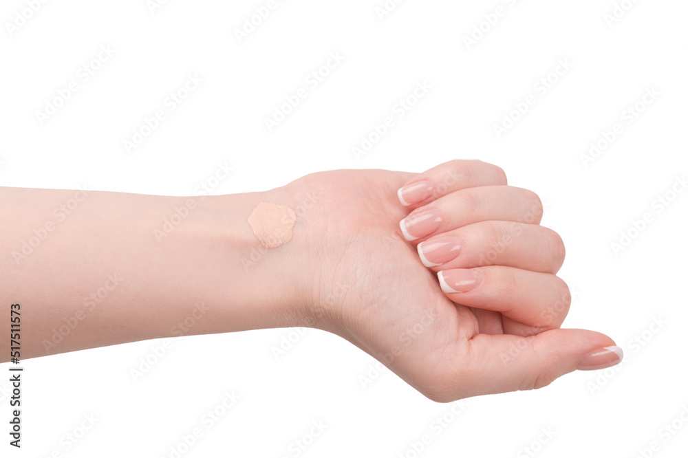 Swatch of foundation on a woman hand isolated on white background.