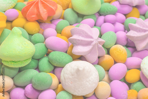 Colorful meringues and glazed peanuts isolated on a white background.