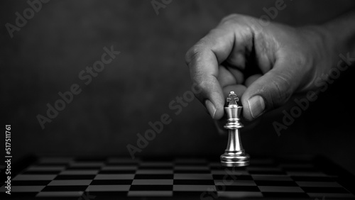 Hand choose king chess for fight on chess board concept of team player or business team and leadership strategy and human resources organization management.