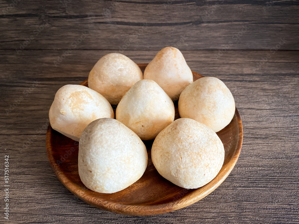Straw mushroom in the wooden plate on the table Straw mushroom in the wooden plate on the table