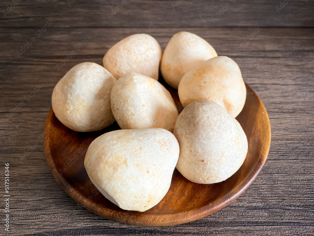 Straw mushroom in the wooden plate on the table Straw mushroom in the wooden plate on the table