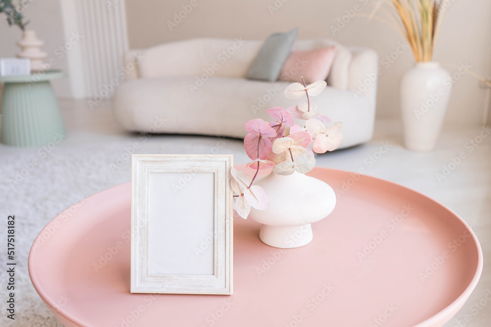 Portrait white picture frame mockup on table. Modern ceramic vase. Scandinavian interior. Portrait white picture frame mockup on table. Modern ceramic vase. Scandinavian interior.