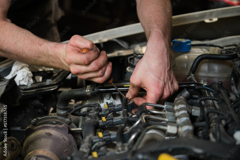 Technician removing fuel injectors in engine room checking dust and test pressure in maintenance process. Technician removing fuel injectors in engine room checking dust and test pressure in maintenance process.