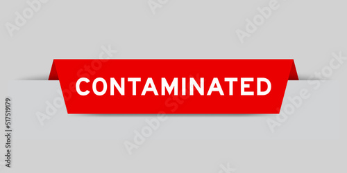 Red color inserted label with word contaminated on gray background