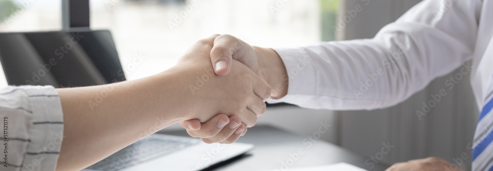Business personage handshake, Asian businessman congratulate on being a corporate partnership with European woman investors, Friendship, Sign language greetings, Successful business negotiations.
