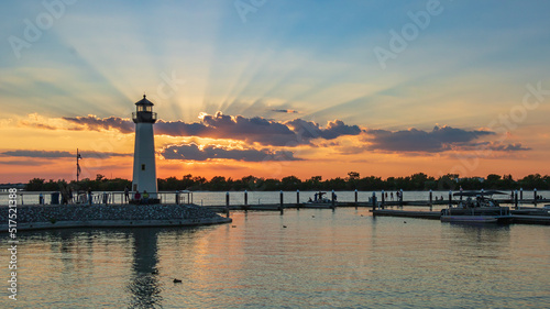 Sensational Sunset with a Lighthouse at a Marina photo