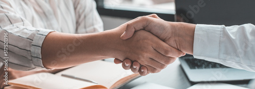 Business personage handshake, Asian businessman congratulate on being a corporate partnership with European woman investors, Friendship, Sign language greetings, Successful business negotiations.