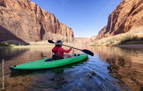 Adventurous Woman on a Kayak paddling in Colorado River. Glen Canyon, Arizona, United States of America. American Mountain Nature Landscape Background. Adventure Travel © edb3_16