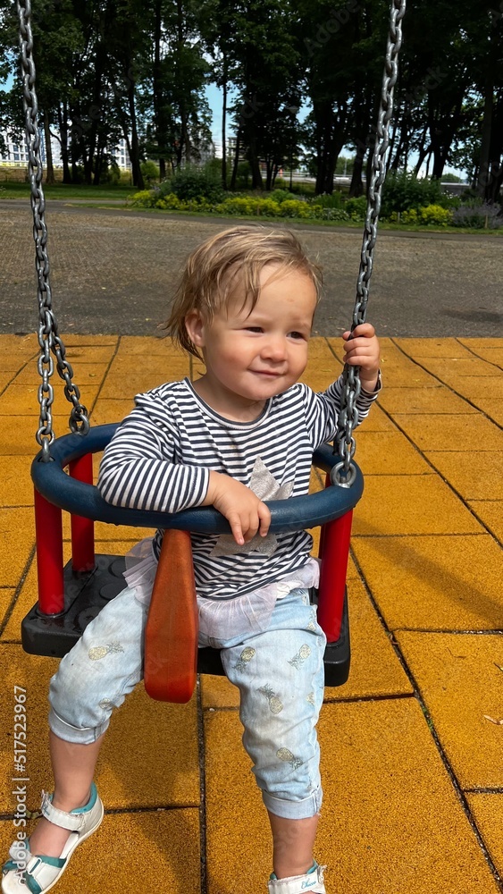 custom made wallpaper toronto digitalHappy toddler sitting in a swing at the playground