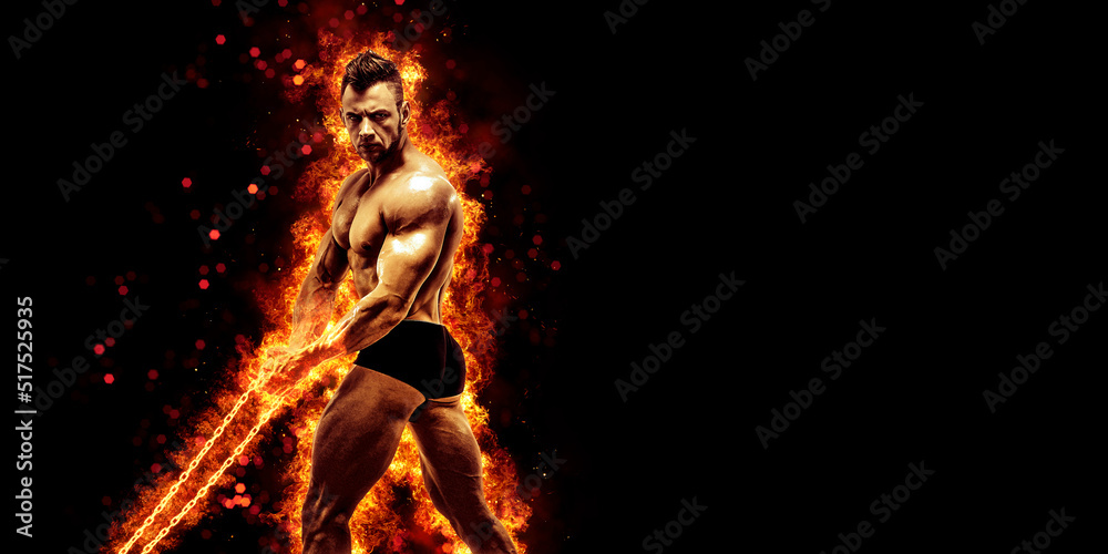 Fototapeta premium Body builder with fit torso belly chest and arms biceps triceps muscles holding chain while posing over the black background with fire. Bodybuilding concept 