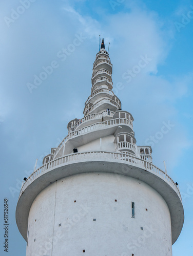 Gampola, Kandy , Sri Lanka - March 10, 2022: View of Ambuluwawa Tower with sky and clouds in the background. Vertical photo