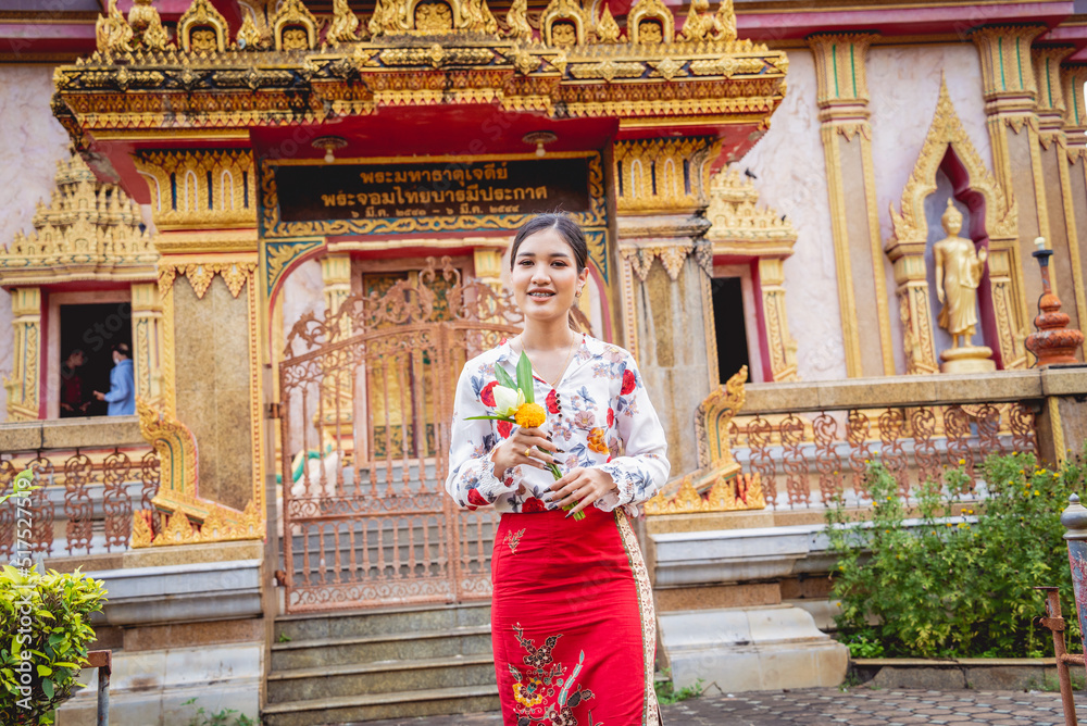 Fototapeta premium Beautiful Asian girl at big Buddhist temple dressed in traditional costume