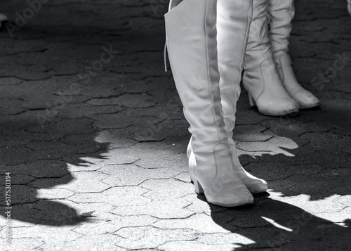 High white boots on the feet of the members of the majorette team.