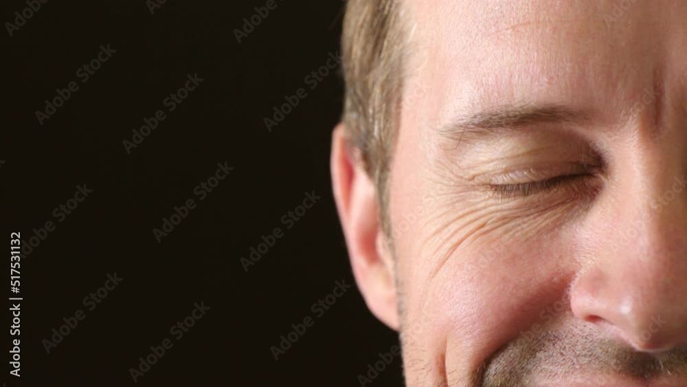 Portrait of a cheerful, happy and confident man smiling and laughing with joy. Face and eyes of a mature caucasian guy feeling excited and positive in a good mood against a black copyspace background Portrait of a cheerful, happy and confident man smiling and laughing with joy. Face and eyes of a mature caucasian guy feeling excited and positive in a good mood against a black copyspace background
