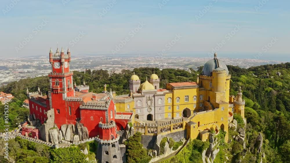 Scenic above view from flying drone touring Palace Pena in Sintra westernmost point of european touristic country Portugal castle gabled facade with red yellow high towers in gothic renaissance style