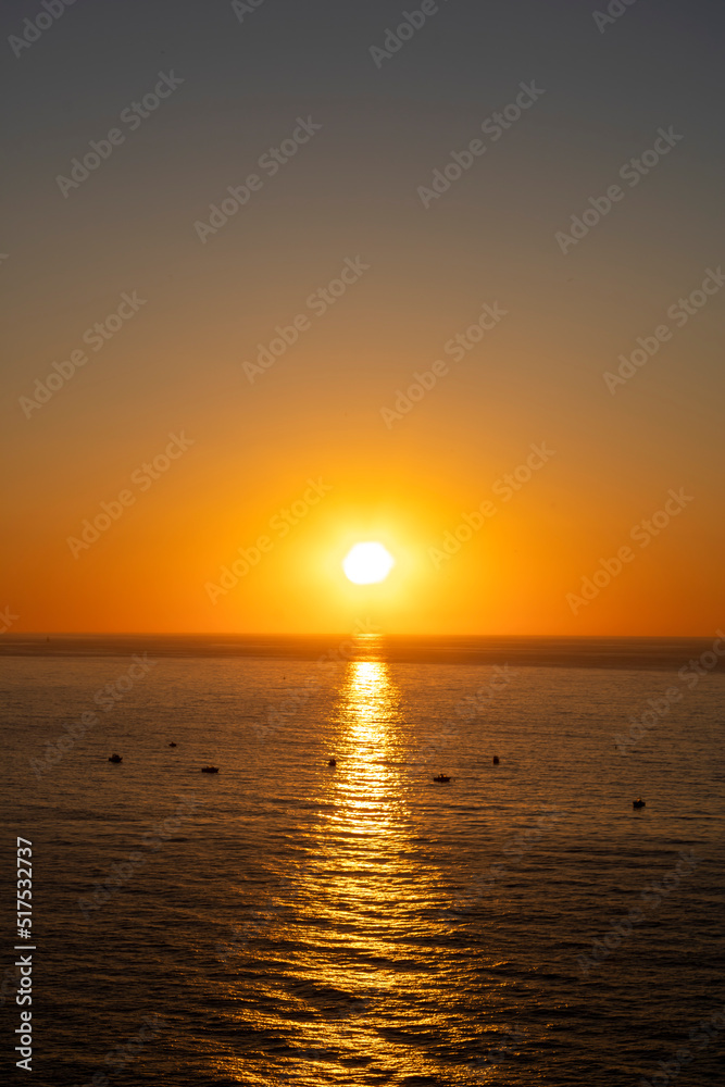 Beautiful sunset over the sea with boat in the middle